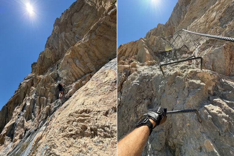 Climber ascending a rugged rock face under bright sun, secured by rope and anchors on a steep cliff