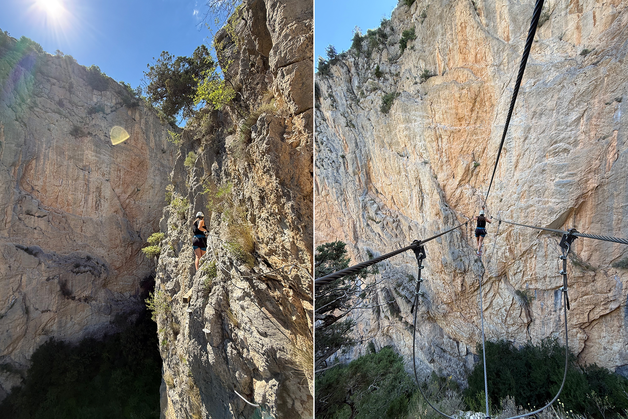 Person wearing a helmet crosses a high rope bridge along a rocky canyon wall under a bright blue sky.