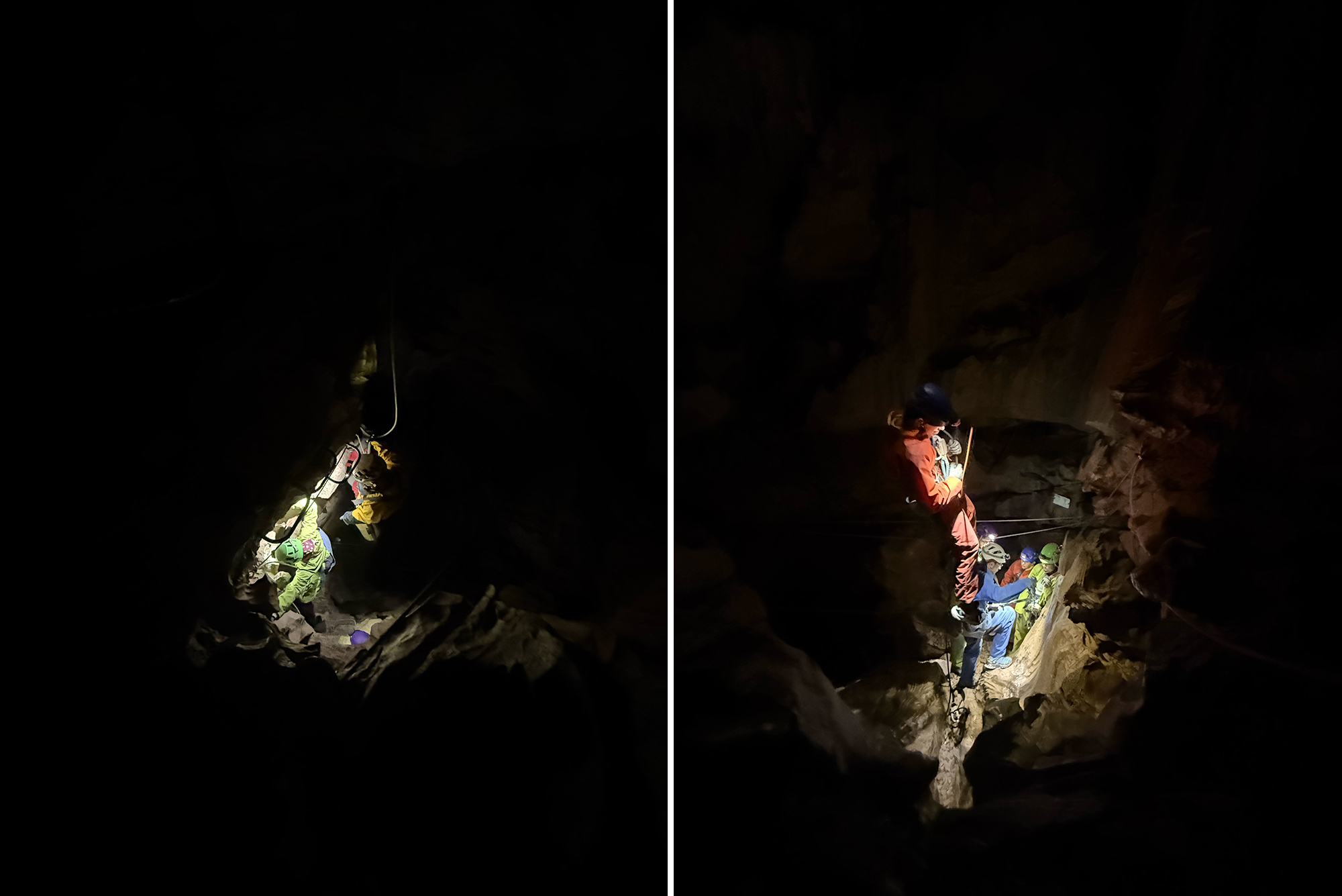 Cave explorers wearing helmets and headlamps, clipped to ropes, standing on a rocky ledge in a dark cavern.