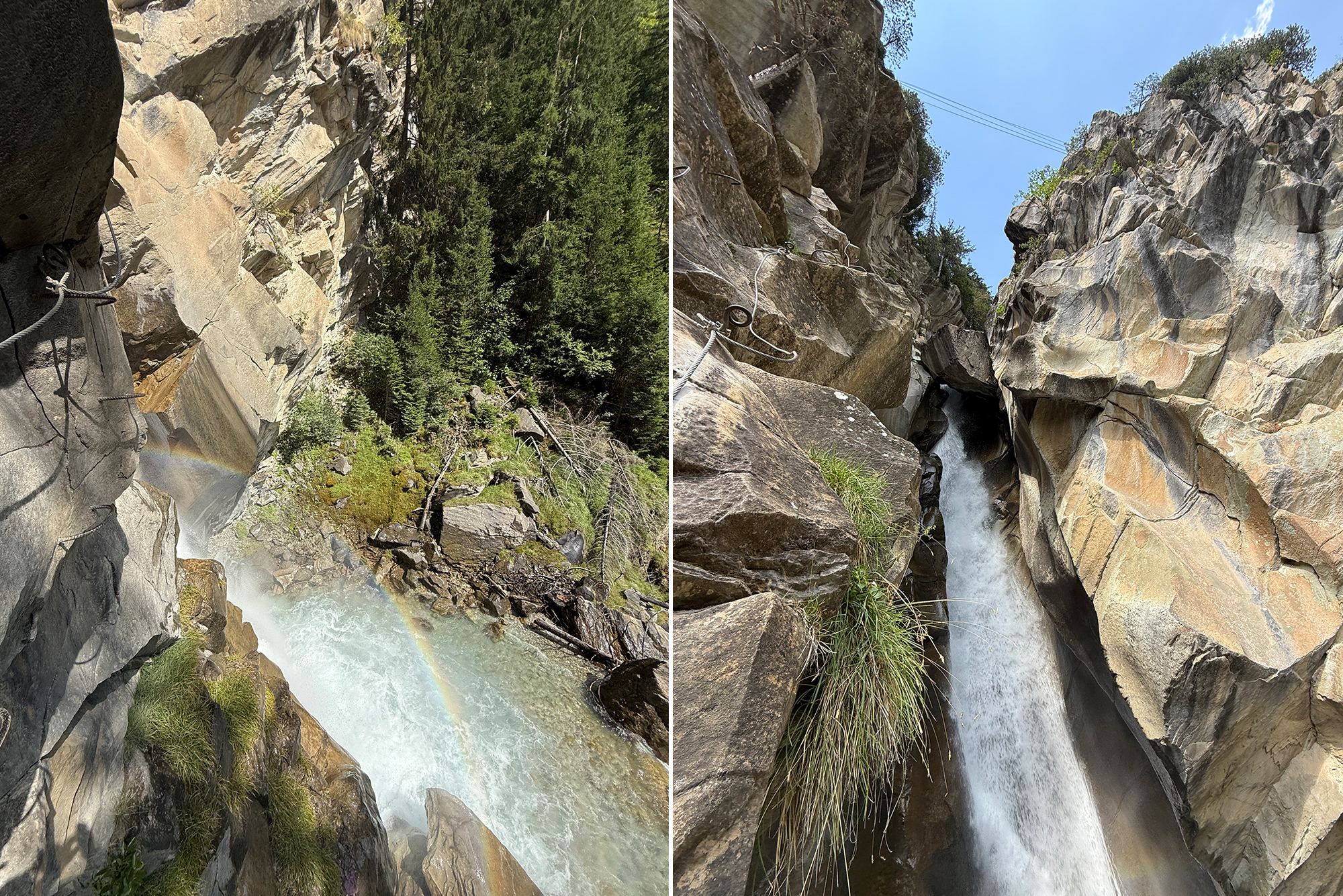 Rugged canyon with a narrow waterfall cascading between large gray rocks; mist rises and a partial rainbow appears at the base, with trees on the far side.